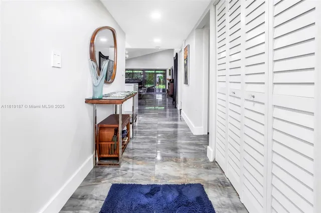 a view of entryway and hall with wooden floor