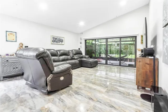 a living room with furniture and a floor to ceiling window