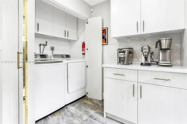 a kitchen with white cabinets and white appliances