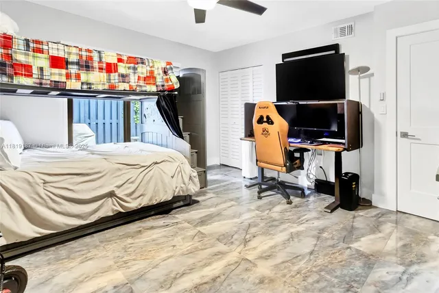 a bedroom with a bed and flat screen tv