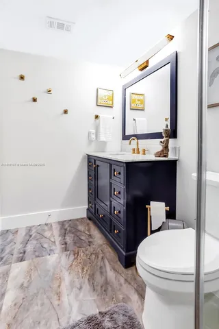 a bathroom with a sink a toilet and mirror