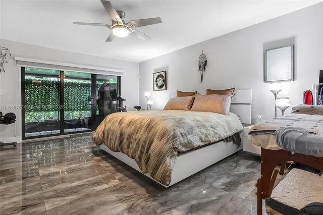 a bedroom with a bed and a large window