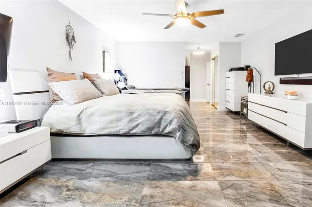 a bedroom with a bed and flat screen tv