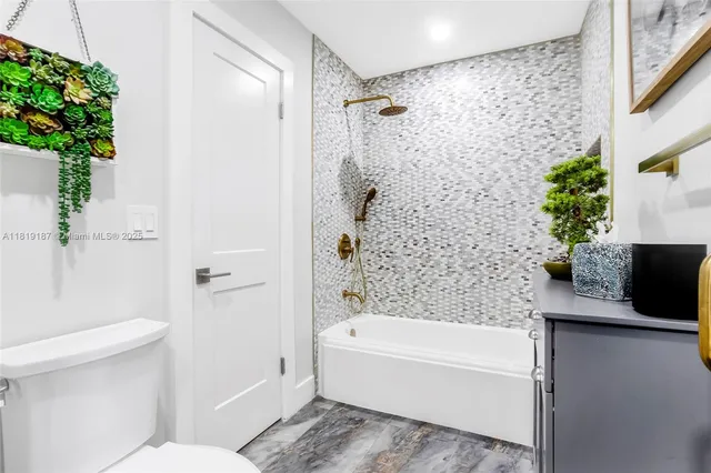 a bathroom with a bathtub and shower