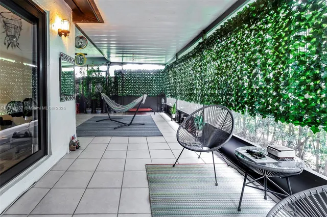 a view of a chairs and table in the patio with a backyard