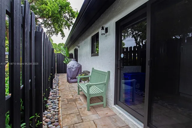 a view of a chairs and table in backyard of the house