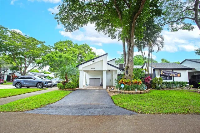 a front view of house with yard and green space