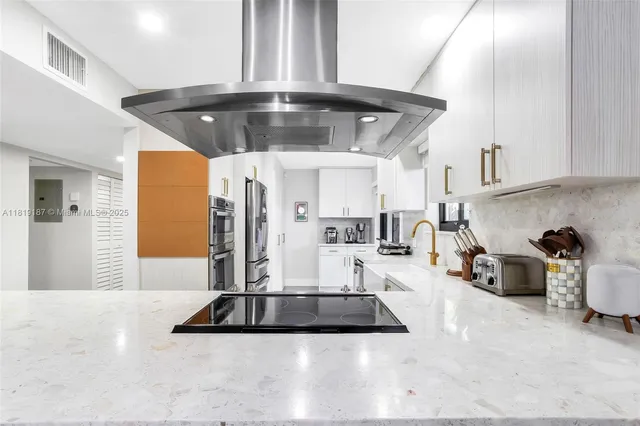 a view of kitchen with furniture and refrigerator