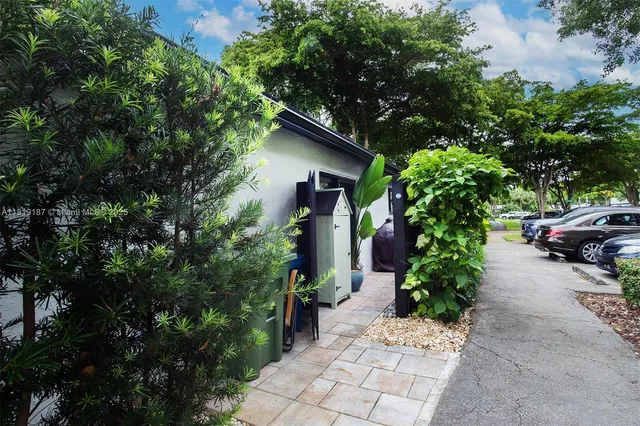 a front view of a house with a yard and trees