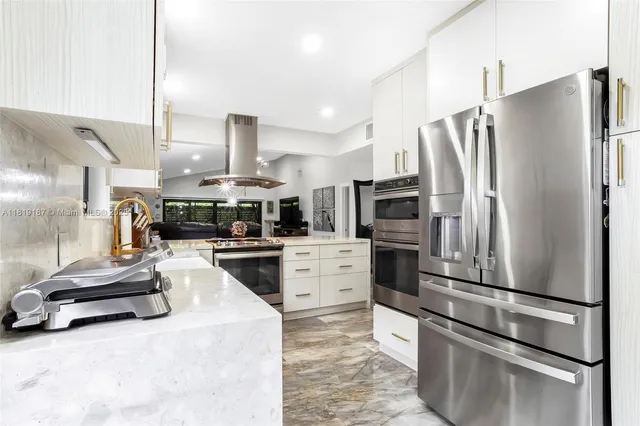 a kitchen with stainless steel appliances a refrigerator sink and stove