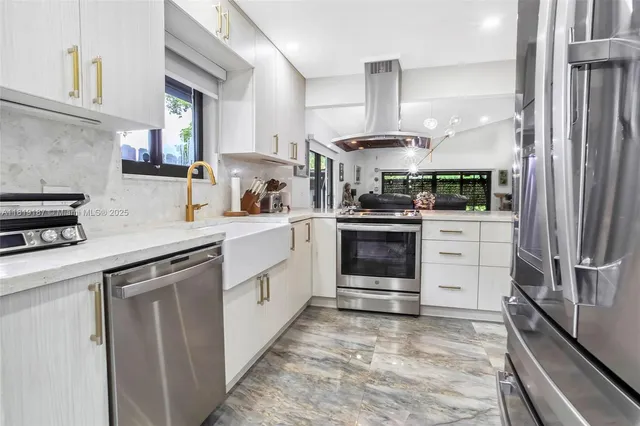 a kitchen with a sink stove and cabinets