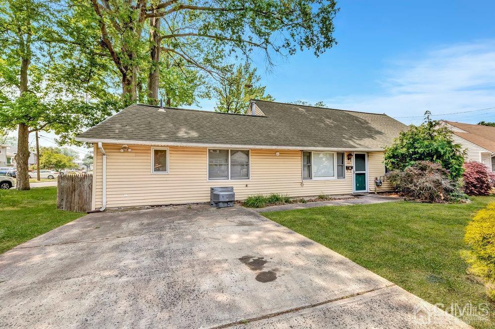 a front view of a house with a garden and yard