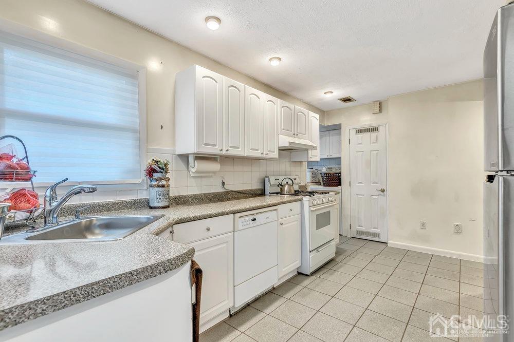 122 Vineyard Road Edison, NJ 08817 - Photo 12 of 24 a kitchen with a sink window and cabinets