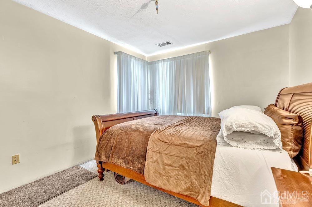 122 Vineyard Road Edison, NJ 08817 - Photo 16 of 24 a bedroom with a bed and a window