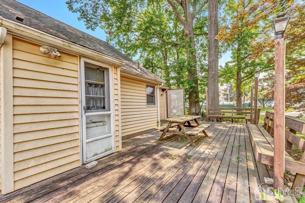 122 Vineyard Road Edison, NJ 08817 - Photo 21 of 24 a view of a patio with a table and chairs and wooden floor