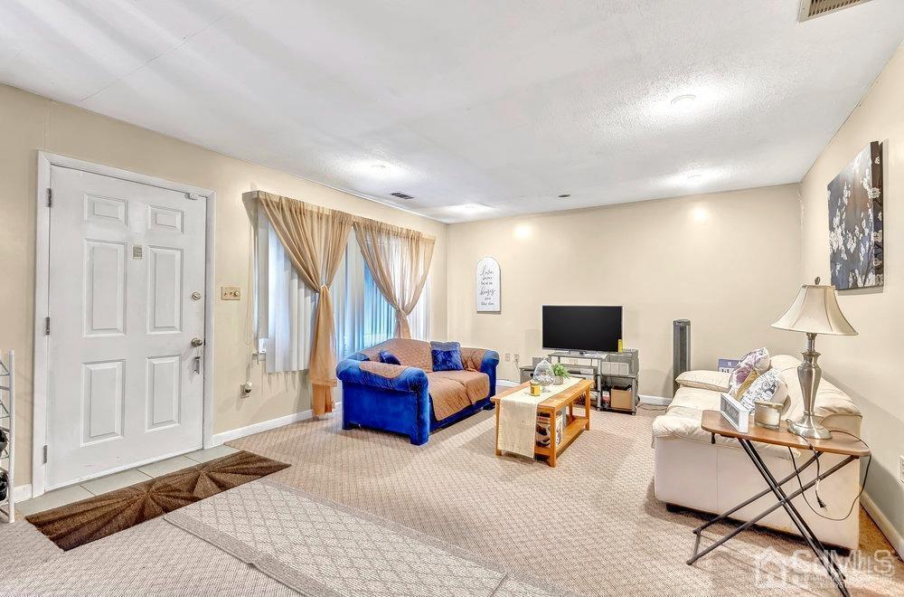 122 Vineyard Road Edison, NJ 08817 - Photo 4 of 24 a living room with furniture and a flat screen tv