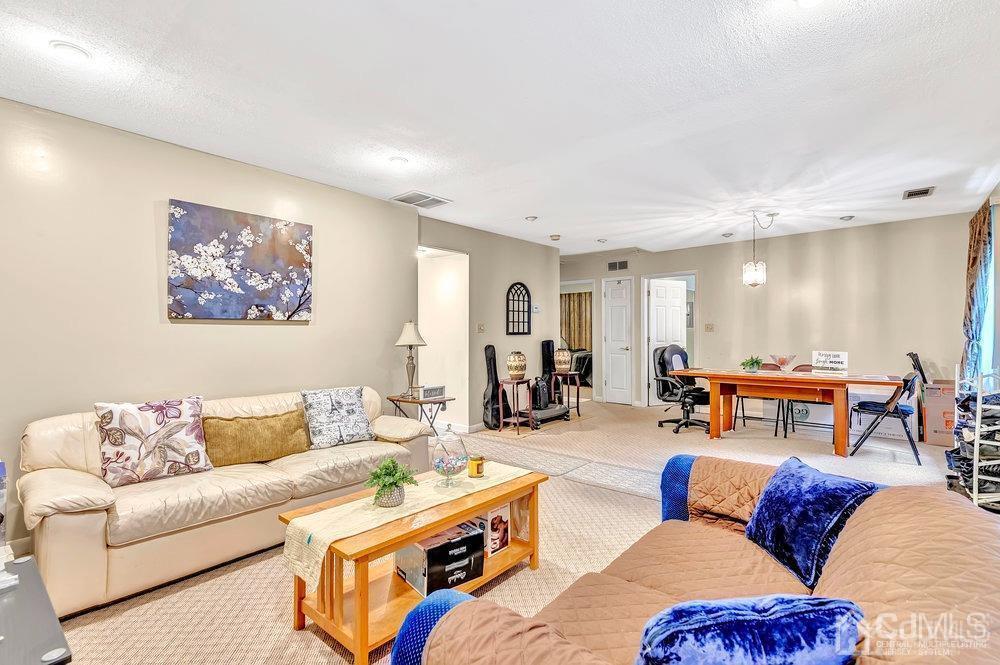 122 Vineyard Road Edison, NJ 08817 - Photo 5 of 24 a living room with furniture a table and a painting