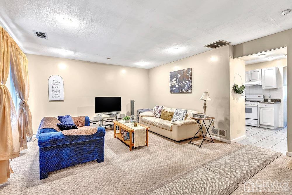 122 Vineyard Road Edison, NJ 08817 - Photo 6 of 24 a living room with furniture and a flat screen tv