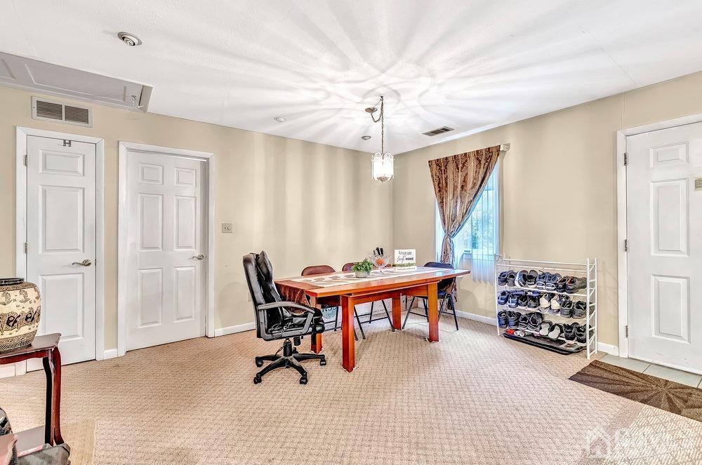 122 Vineyard Road Edison, NJ 08817 - Photo 7 of 24 a room with furniture a chandelier and a window