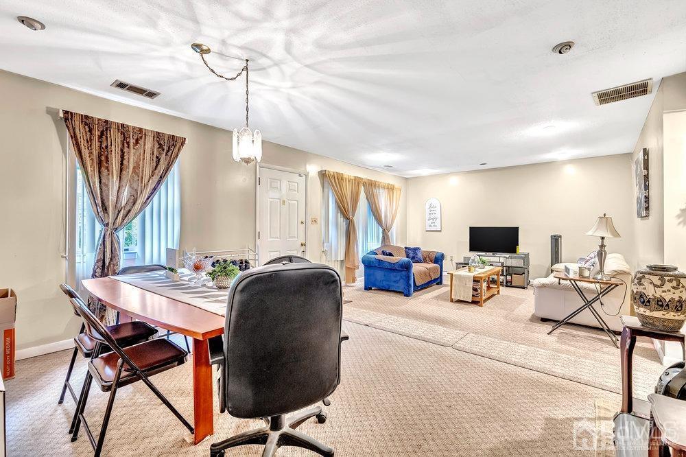 122 Vineyard Road Edison, NJ 08817 - Photo 8 of 24 a living room with furniture a flat screen tv and a window