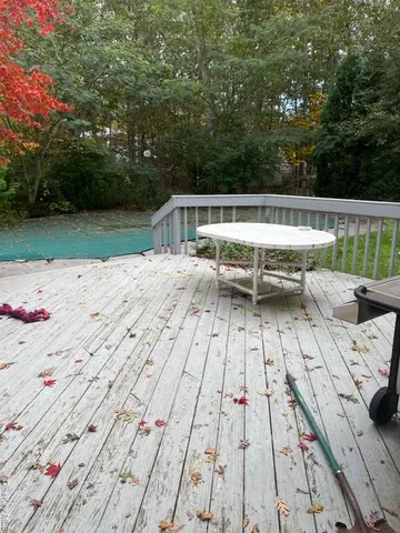 swimming pool view with a seating space
