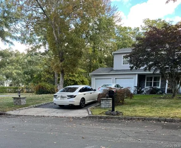a car parked in front of white house