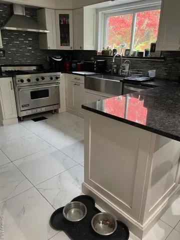 a kitchen with a stove and a window