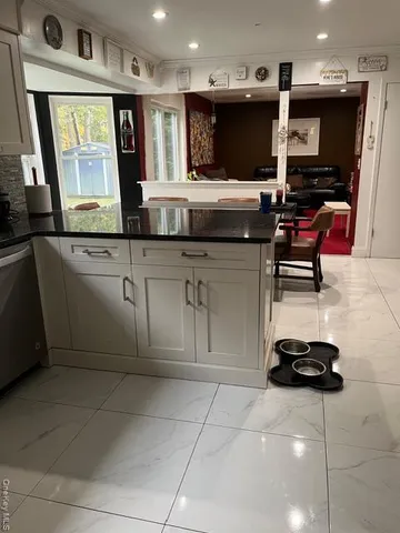 a kitchen with stainless steel appliances a stove sink and microwave
