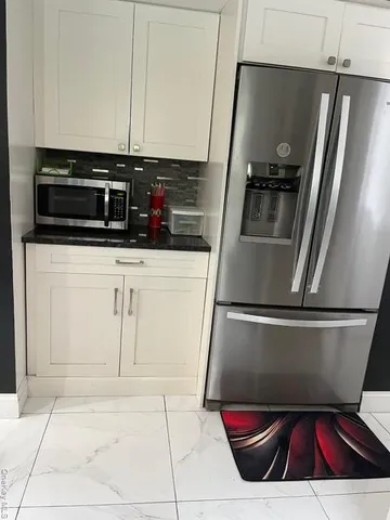 a kitchen with a refrigerator and a sink