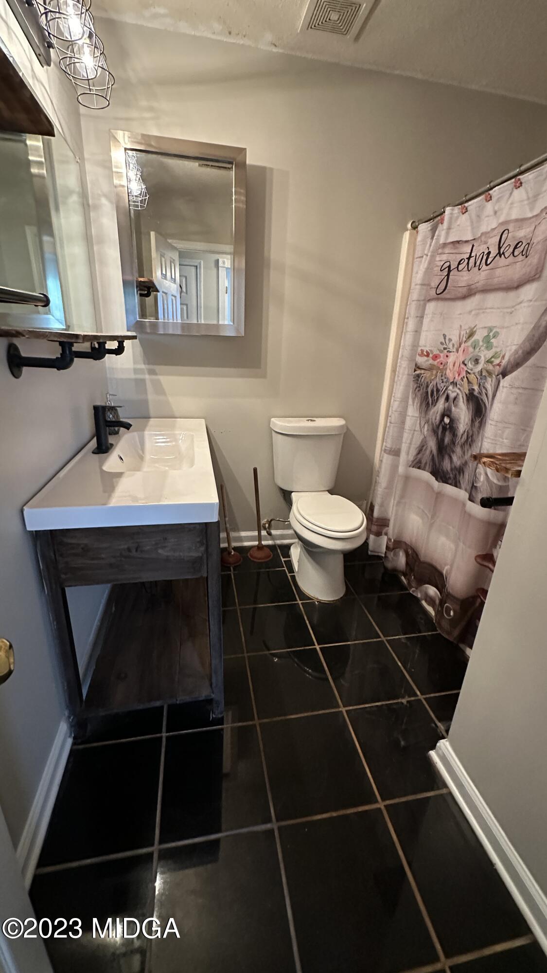 134 Haley Road Jackson, GA 30233 - Photo 11 of 11 a bathroom with a sink toilet and mirror
