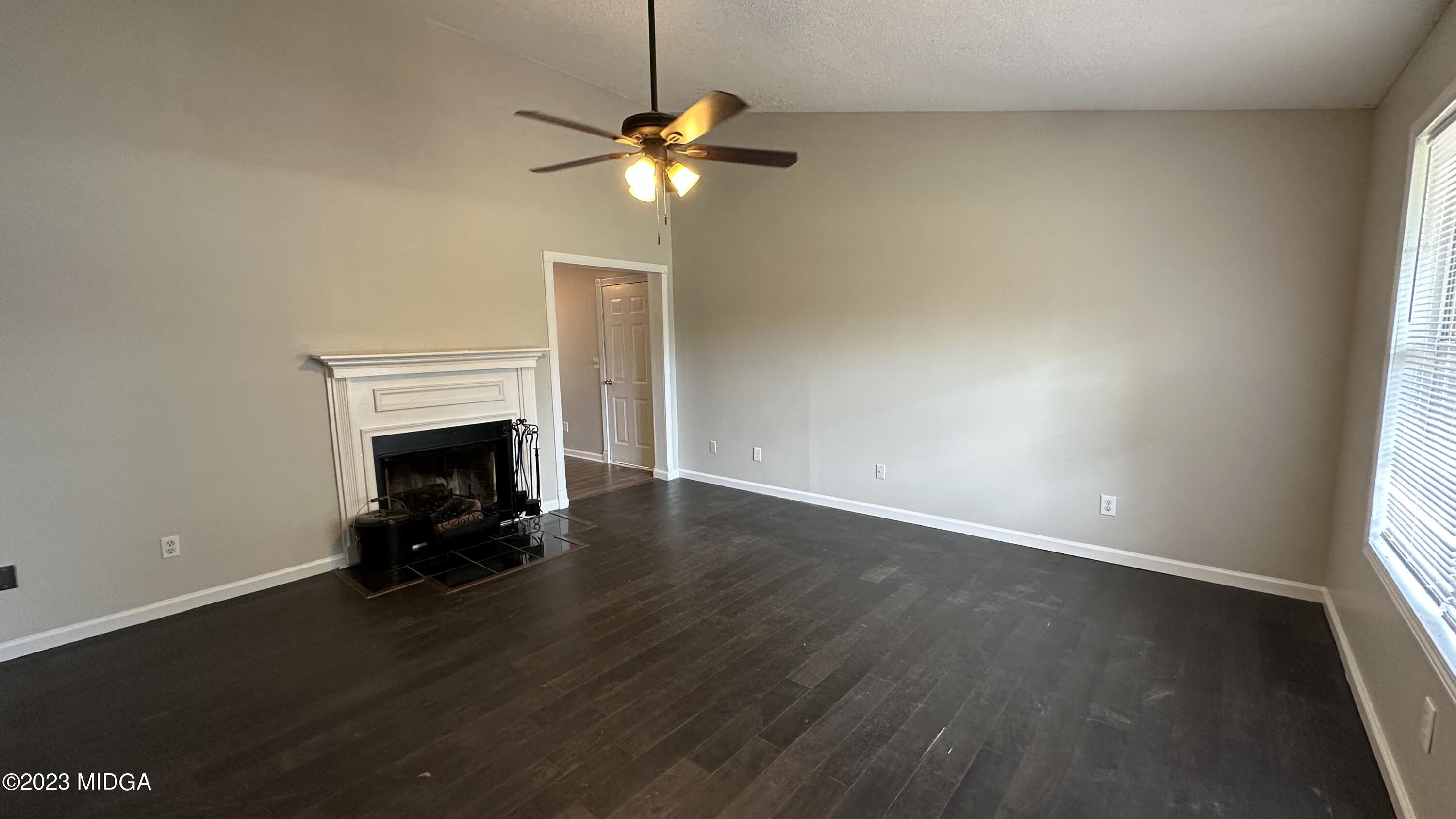 134 Haley Road Jackson, GA 30233 - Photo 2 of 11 a view of empty room with wooden floor and fireplace