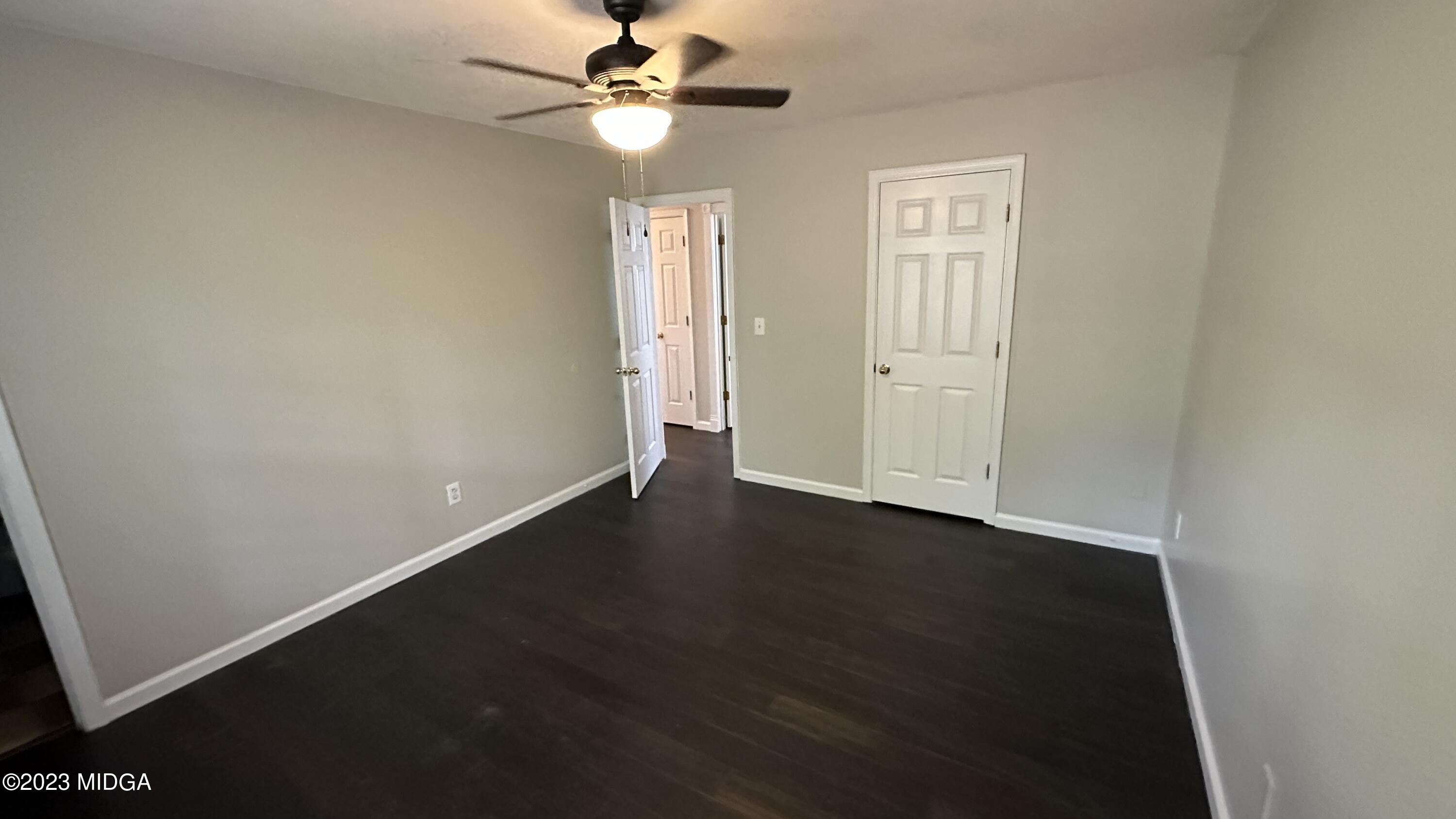 134 Haley Road Jackson, GA 30233 - Photo 6 of 11 an empty room with wooden floor fan and windows
