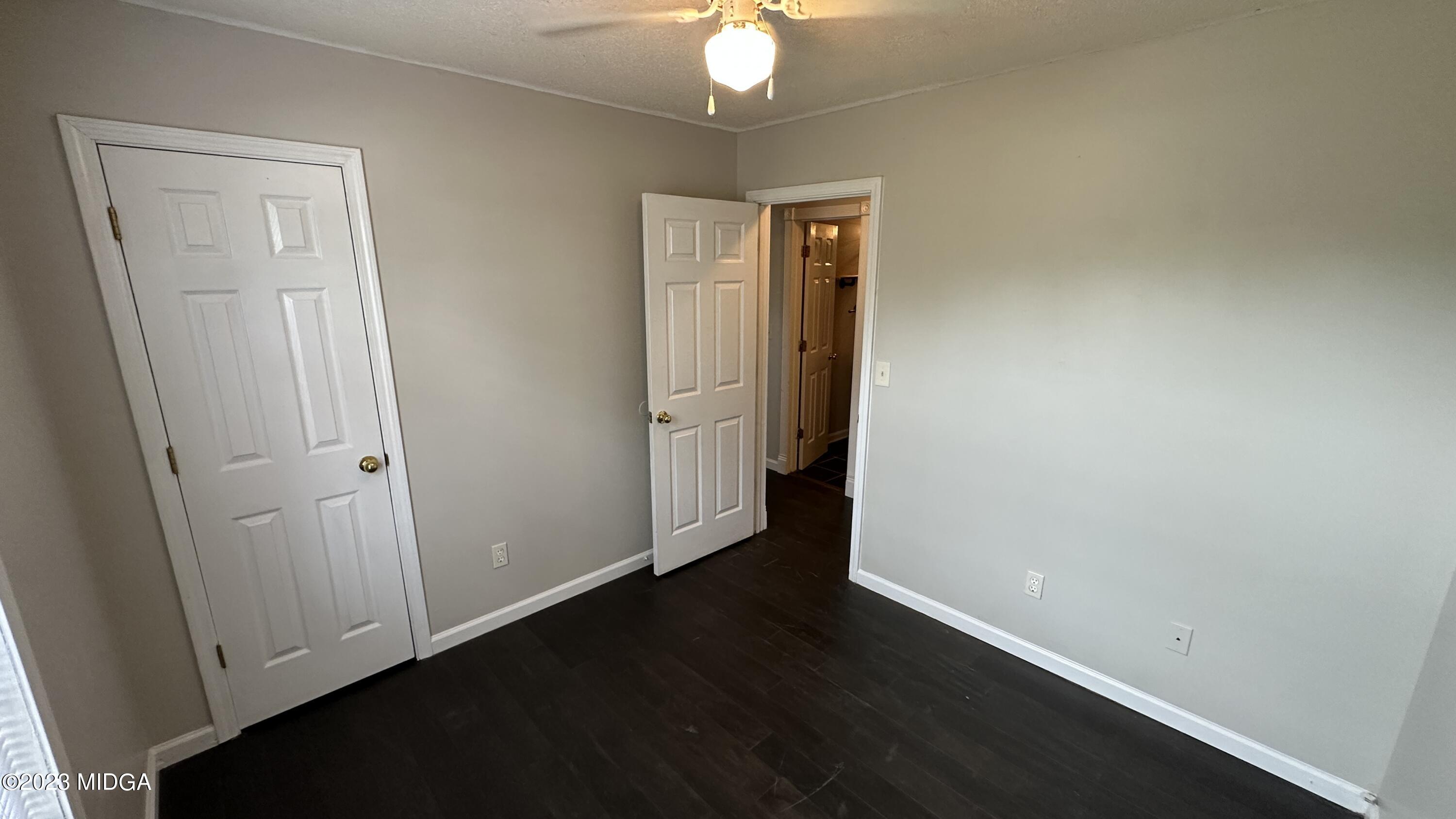 134 Haley Road Jackson, GA 30233 - Photo 8 of 11 an empty room with wooden floor and closet area
