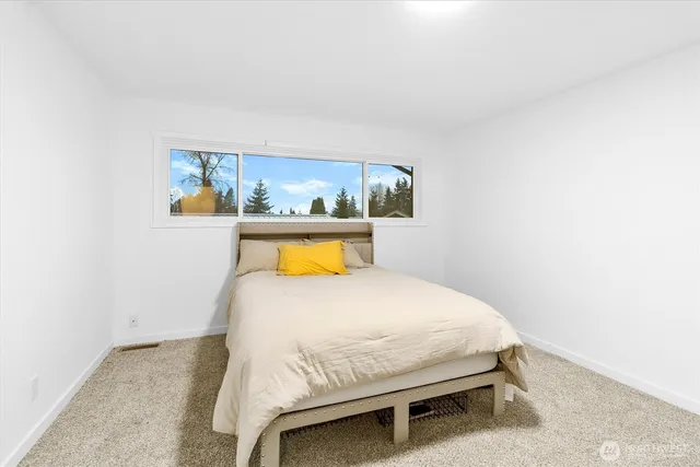 a bedroom with a bed and a table