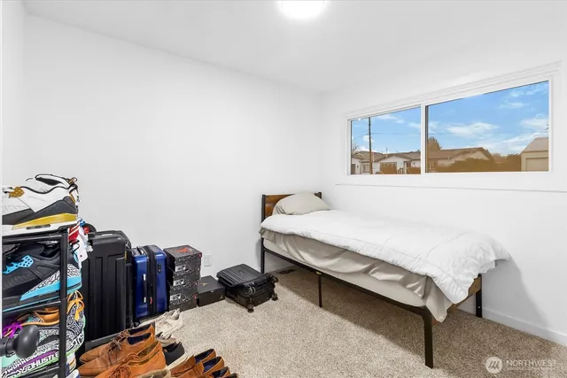 a bed sitting in a bedroom next to a window