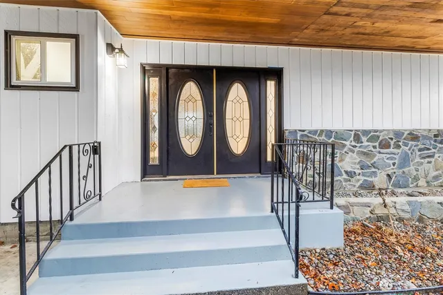 an entryway with painting on the wall