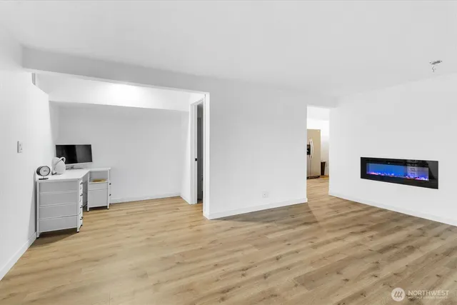 a view of a big room with wooden floor and a bathroom