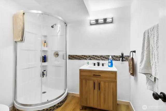 a bathroom with a sink toilet and shower