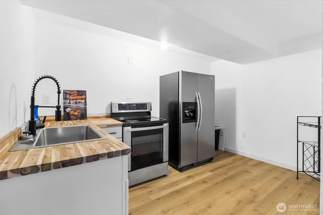 a kitchen with a refrigerator sink and stove