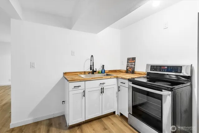 a kitchen with a stove oven and sink