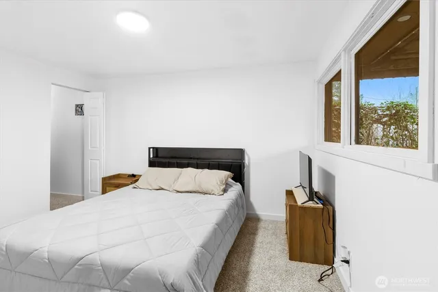 a bedroom with a bed and window