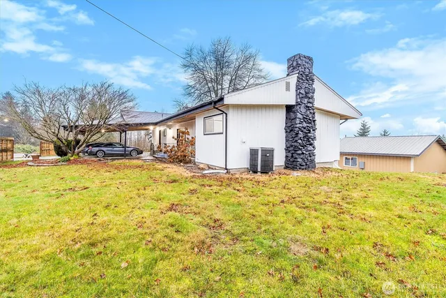 a view of a yard with large trees