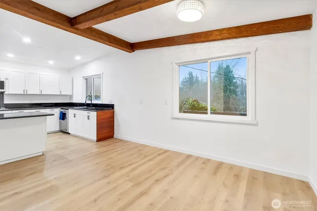 a view of kitchen with wooden floor and electronic appliances