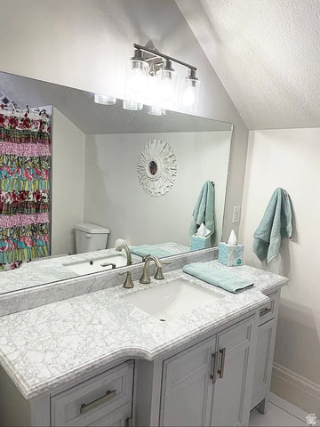 838 East Mountain Road North Ogden, UT 84414 - Photo 25 of 37 Vanity with undermount sink, intricate patterned countertop, and light gray cabinetry