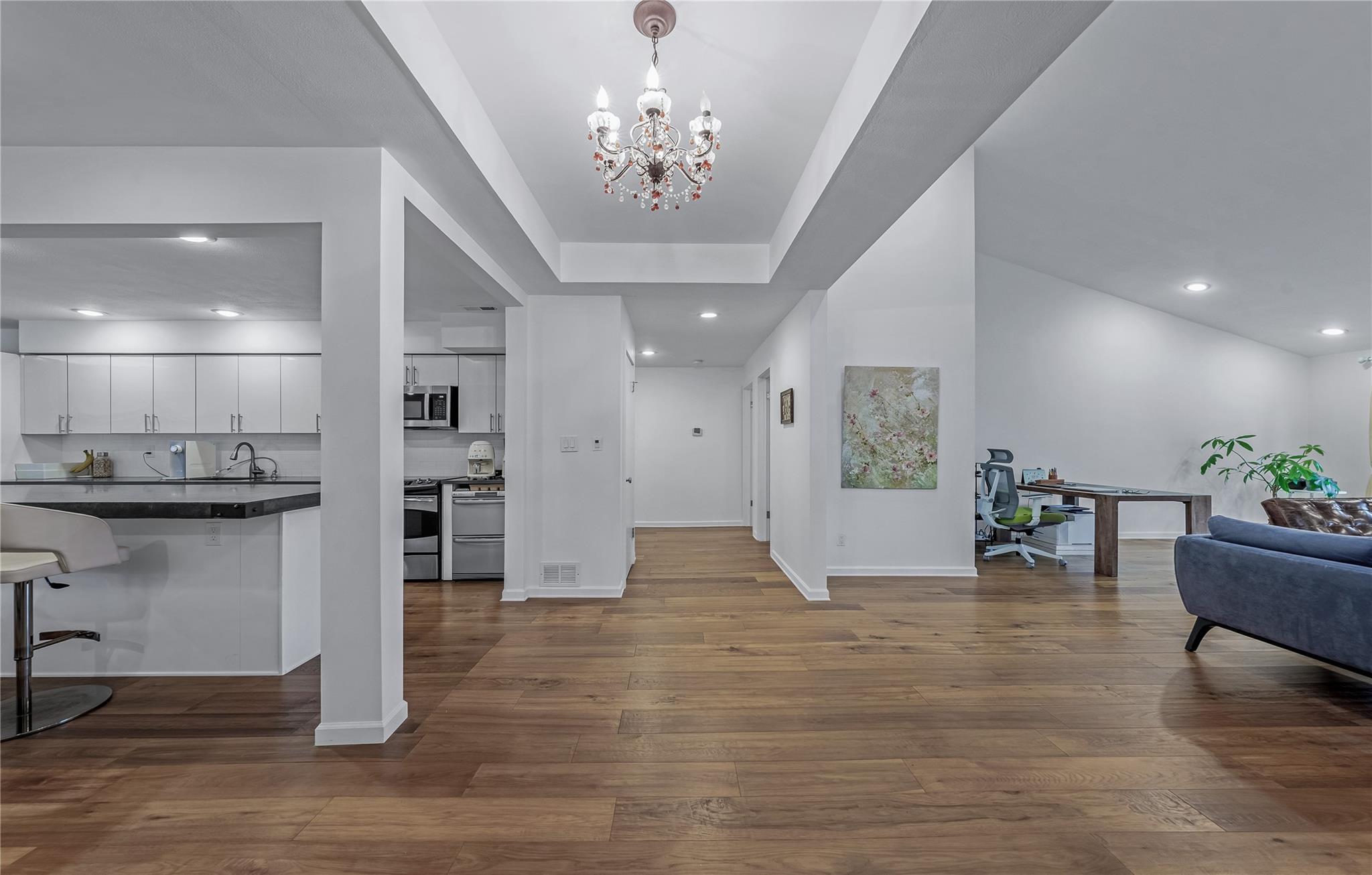 a living room with furniture and kitchen view