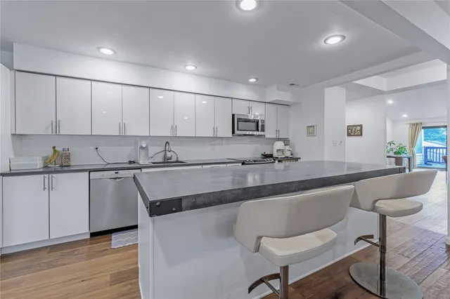 a kitchen with a refrigerator and a stove top oven