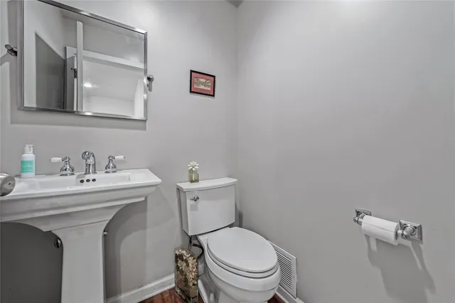 a spacious bedroom with a bed and wooden floor