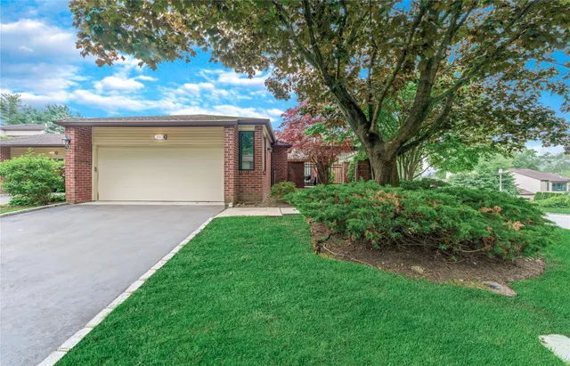 a front view of a house with a garden and yard