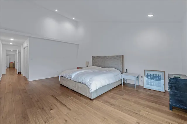 a bedroom with a bed and a large window