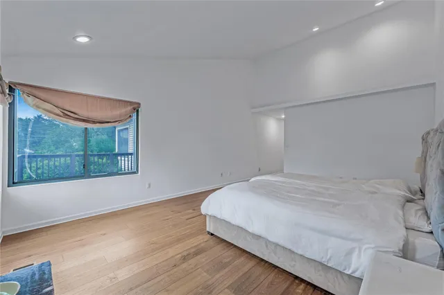a spacious bathroom with a bathtub sink and mirror